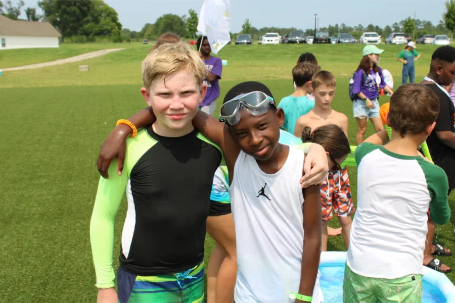 Two campers hugging after playing outside